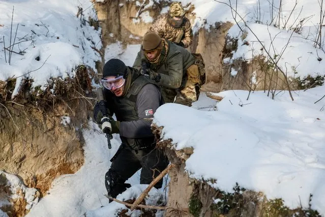 Ukrainian civilians take part in the final exercise of a five-day basic military training, amid Russia's attack on Ukraine, near Kyiv, Ukraine on January 12, 2024. (Photo by Alina Smutko/Reuters)