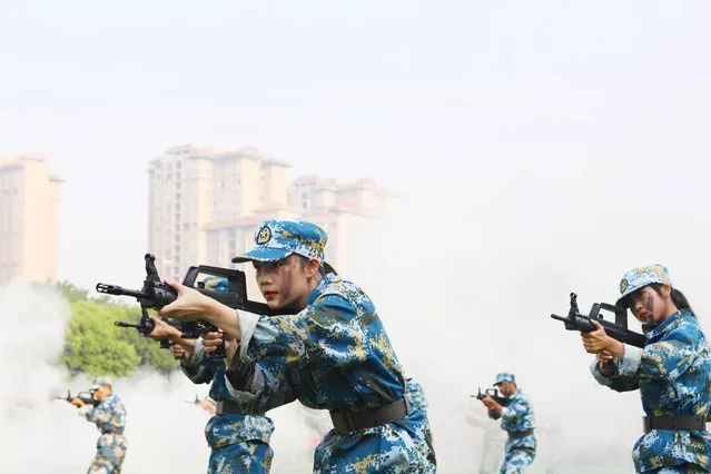 Freshmen take part in a military training at Chongqing City Vocational College on September 23, 2021 in Chongqing, China. (Photo by Chen Shichuan/VCG via Getty Images)
