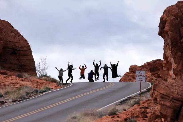 Tourists from South Korea jump as they take a group photo near Elephant Rock in the Valley of Fire State Park, Nevada on February 7, 2024. (Photo by David Swanson/Reuters)