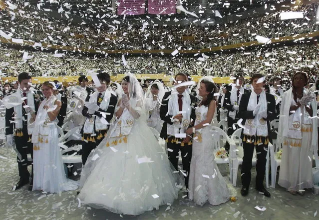 Couples from around the world participate in a mass wedding ceremony at the CheongShim Peace World Center in Gapyeong, South Korea, Wednesday, February 12, 2014. (Photo by Lee Jin-man/AP Photo)