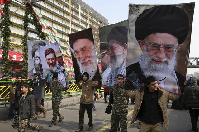 Iranians march while carrying various portraits of Supreme Leader Ayatollah Ali Khamenei in an annual rally commemorating the anniversary of the 1979 Islamic revolution, which toppled the late pro-U.S. Shah, Mohammad Reza Pahlavi, in Tehran, Iran, Friday, February 10, 2017. (Photo by Vahid Salemi/AP Photo)