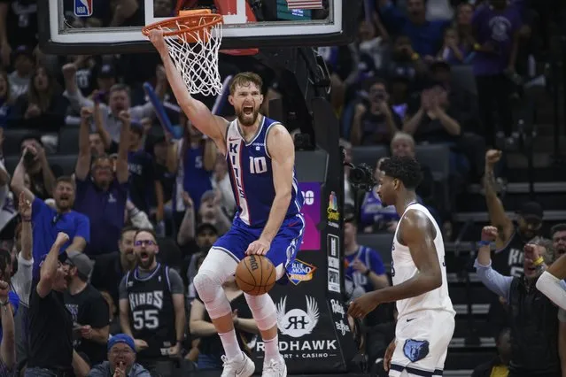 Sacramento Kings forward Domantas Sabonis (10) reacts after dunking the ball during the second half of an NBA basketball game against the Memphis Grizzlies in Sacramento, Calif., Monday, March 18, 2024. The Kings won in overtime 121-111. (Photo by Randall Benton/AP Photo)