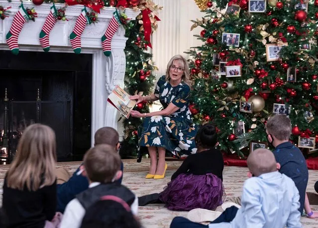 US First Lady Jill Biden reads to students from Malcolm Elementary School, from Waldorf, Maryland, during an event in the State Dining Room at the White House in Washington, DC on November 29, 2021. (Photo by Andrew Caballero-Reynolds/AFP Photo)