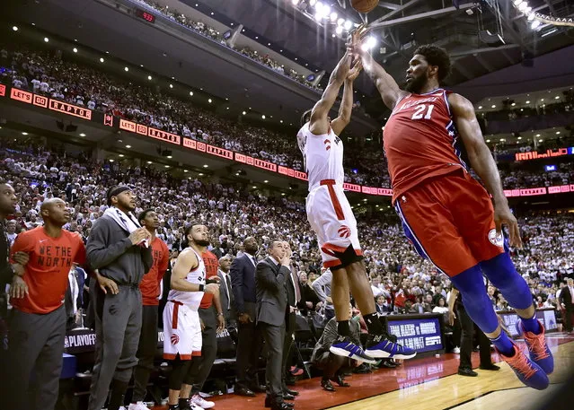 Philadelphia 76ers center Joel Embiid (21) fails to stop Toronto Raptors forward Kawhi Leonard's (2) last-second basket during the second half of an NBA Eastern Conference semifinal basketball game in Toronto on Sunday, May 12, 2019. (Photo by Frank Gunn/The Canadian Press via AP Photo)