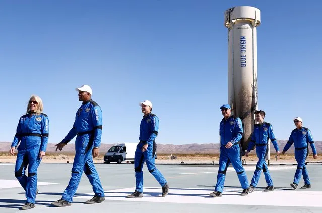 (L to R) Laura Shepard Churchley, daughter of astronaut Alan Shepard, Good Morning America co-anchor and former NFL star Michael Strahan, Dylan Taylor, Chairman & CEO of Voyager Space, venture capitalist Lane Bess and his son Cameron, and investor Evan Dick, walk during a media availability on the landing pad after they flew into space aboard Blue Origin's New Shepard on December 11, 2021 near Van Horn, Texas. (Photo by Mario Tama/Getty Images/AFP Photo)