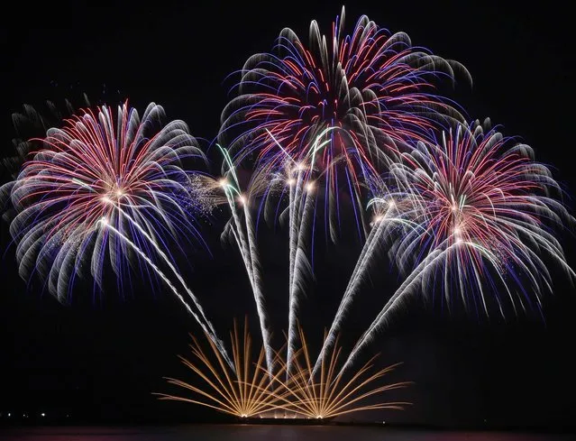 Fireworks from Germany's Vulcan Europe dot the sky on the fourth weekend of the 5th Philippine International Pyromusical Competition at the seaside Mall of Asia in suburban Pasay city, south of Manila, Philippines, on March 8, 2014. The fireworks display features competitors from China, Canada, Finland, France, Germany, Japan, Spain, the United Kingdom, the United States and the Philippines. (Photo by Bullit Marquez/Associated Press)