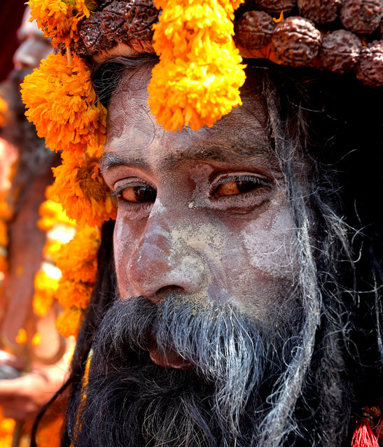 An Indian Naga Sadhu (holy man) looks on as he takes part in the religious procession prior to the one-month long Simhastha Kumbh Mela festival in Ujjain, some 180 km from Bhopal, India, 05 April 2016. Kumbh Mela is a mass Hindu pilgrimage which occurs every twelve years and rotates among four locations. The festival is held from 22 April to 21 May. (Photo by Sanjeev Gupta/EPA)