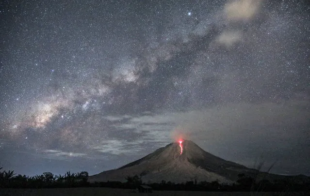 A long exposure picture shows molten lava spilling from the Mount Sinabung as seen from Sukandebi village in Karo, North Sumatra, Indonesia, 02 August 2017. Mount Sinabung is one of the most active volcanos in Indonesia. It erupted in 2010 and since then killed 16 people in eruptions in 2014 and another nine people in 2016. (Photo by Dedi Sinuhaji/EPA)