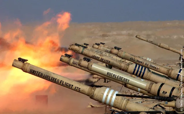 A row of U.S. Army M1/A1 Abrahams tanks from Task Force 1-64  fire live rounds during a live fire training session