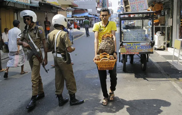 Sri Lankan police officers patrol in a street outside a mosque in Colombo, Sri Lanka, Wednesday, April 24, 2019. The Islamic State group has claimed responsibility for the Sri Lanka attacks on Easter Sunday and released images that purported to show the attackers. Prime Minister Ranil Wickremesinghe said that investigators were still determining the extent of the bombers' foreign links. (Photo by Eranga Jayawardena/AP Photo)