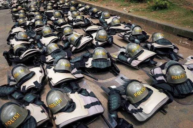 Police riot gears are placed on the ground as people protest against the recent presidential election results in Jakarta on April 22, 2024. (Photo by Yasuyoshi Chiba/AFP Photo)