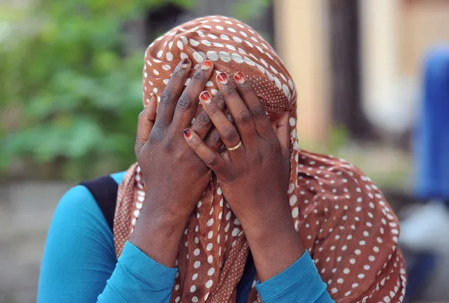 A woman covers her face in Ventimiglia, at the Italian-French border Tuesday, June 16, 2015. Police at Italy's Mediterranean border with France have forcibly removed some of the African migrants who have been camping out for days in hopes of continuing their journeys farther north. The migrants, mostly from Sudan and Eritrea, have been camped out for five days after French border police refused to let them cross. (Luca Zennaro/ANSA via AP)