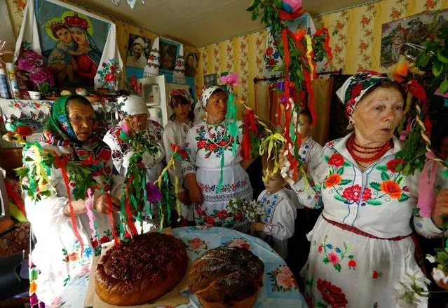 Villagers take part in a ritual celebrating the pagan god Yurya and pray for plentiful future harvests in the village of Pogost, Belarus May 6, 2016. (Photo by Vasily Fedosenko/Reuters)