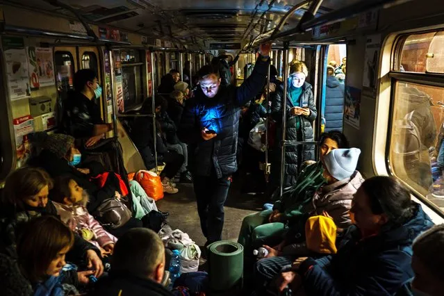 Hundreds of people seek shelter underground, on the platform, inside the dark train cars, and even in the emergency exits, in metro subway station as the Russian invasion of Ukraine continues, in Kharkiv, Ukraine, Thursday, February 24, 2022. (Photo by Marcus Yam/Los Angeles Times/Rex Features/Shutterstock)
