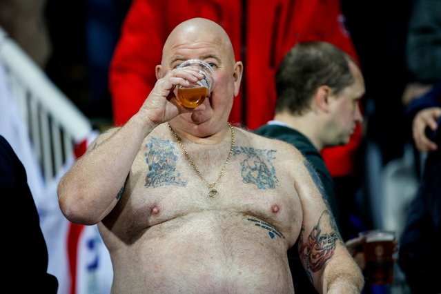 An England supporter drinks beer during the UEFA Euro 2020 qualifying Group A football match between Kosovo and England at the Fadil Vokrri stadium in Prishtina on November 17, 2019. (Photo by Armend Nimani/AFP Photo)