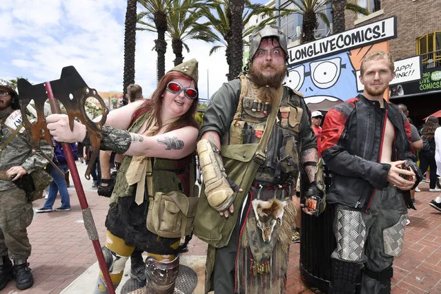 Costumed characters work the crowds on Fifth Avenue outside the convention center on the second day of the 2015 Comic-Con International held at the San Diego Convention Center Friday, July 10, 2015, in San Diego.  (Photo by Denis Poroy/Invision/AP Photo)