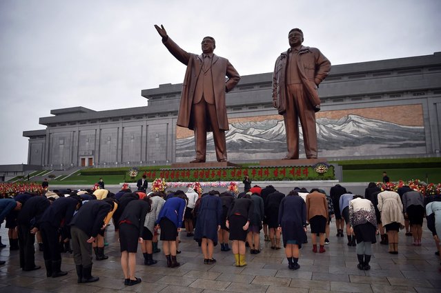 People bow to pay tribute to the statues of late North Korean leaders Kim Il Sung and Kim Jong Il on Mansu Hill, as part of celebrations marking the 112th anniversary of the birth of Kim Il Sung, known as the “Day of the Sun”, in Pyongyang on April 15, 2024. (Photo by Kim Won Jin/AFP Photo)