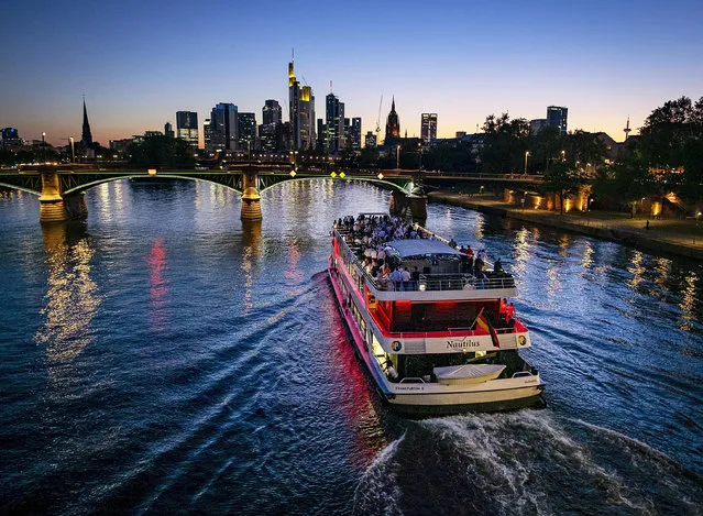 A party ship cruises over the river Main in Frankfurt, Germany, late Thursday, June 27, 2019. (Photo by Michael Probst/AP Photo)