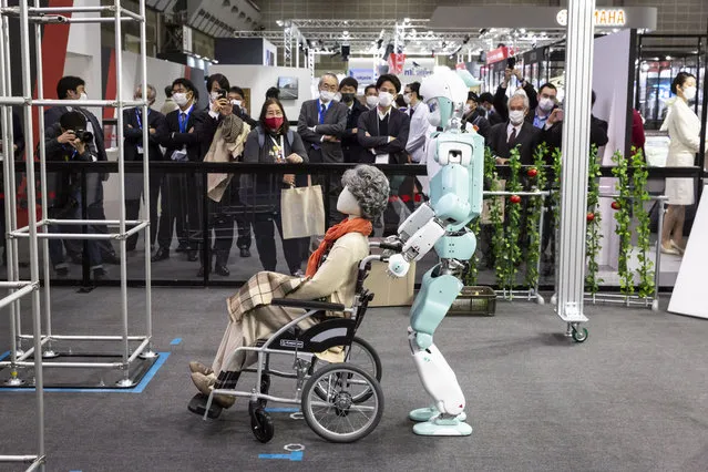 A humanoid robot pushes a wheel chair at Kawasaki Heavy Industries Ltd. booth during the International Robot Exhibition 2022 at Tokyo Big Sight on March 09, 2022 in Tokyo, Japan. The exhibition will be open to public from March 9 to 12, showcasing the robotic technologies related to AI and ICT as well as the latest robots from Japan and around the globe. (Photo by Yuichi Yamazaki/Getty Images)