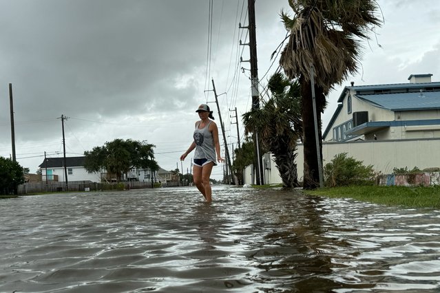 Allison Crane walks out of her flooded neighborhood after Hurricane Beryl passed in Galveston, Texas, U.S. July 8, 2024. (Photo by Rich Matthews/Reuters)