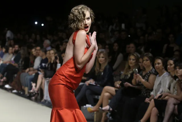 A model strikes a pose as she wears a creation from the Ana Maria Guilfo autumn/winter collection during Fashion Week in Lima, Peru, Thursday, April 27, 2017. (Photo by Martin Mejia/AP Photo)