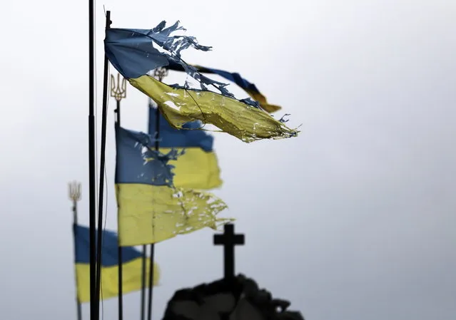 Damaged National flags flutter in the wind on a cemetry of Chernihiv city which was blocked by Russian troops for a long time, Ukraine, 06 April 2022. (Photo by EPA/EFE/Stringer)