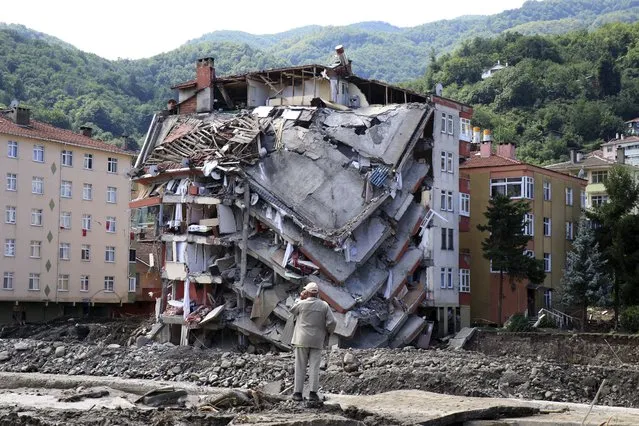 A man looks at destroyed building,  in Bozkurt town of Kastamonu province, Turkey, Saturday, August 14, 2021. The death toll from severe floods and mudslides in coastal Turkey has climbed to at least 44, the country's emergency and disaster agency said Saturday. Torrential rains that pounded the Black Sea provinces of Bartin, Kastamonu and Sinop on Wednesday caused flooding that demolished homes, severed at least five bridges, swept away cars and rendered numerous roads unpassable. (Photo by AP Photo/Stringer)