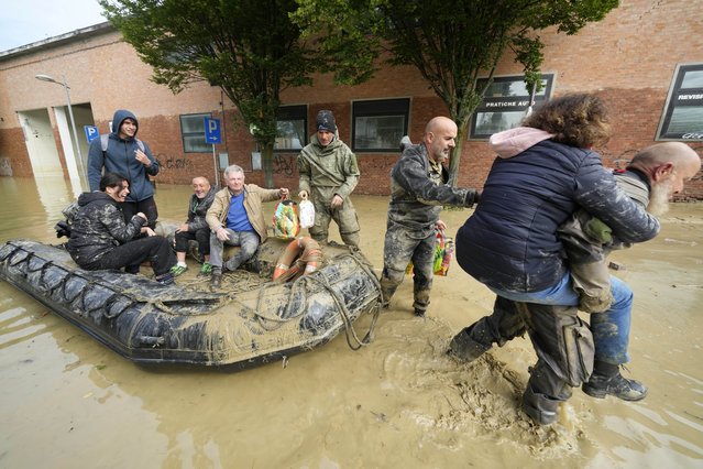 People are rescued in Faenza, Italy, Thursday, May 18, 2023. Exceptional rains Wednesday in a drought-struck region of northern Italy swelled rivers over their banks, killing at least nine people, forcing the evacuation of thousands and prompting officials to warn that Italy needs a national plan to combat climate change-induced flooding. (Photo by Luca Bruno/AP Photo)