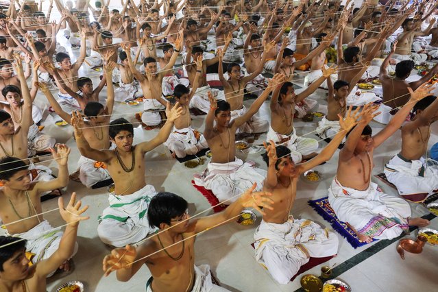 Brahmin Hindu boys take part in the “janeu” (sacred thread), also called “yagnopavit” changing ceremony outside a temple on the occasion of Raksha Bandhan festival in Ahmedabad, India, on August 19, 2024. (Photo by Amit Dave/Reuters)