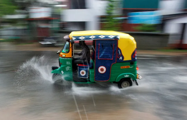 A person drives an auto rickshaw through heavy rains in Agartala, India June 1, 2017. (Photo by Jayanta Dey/Reuters)