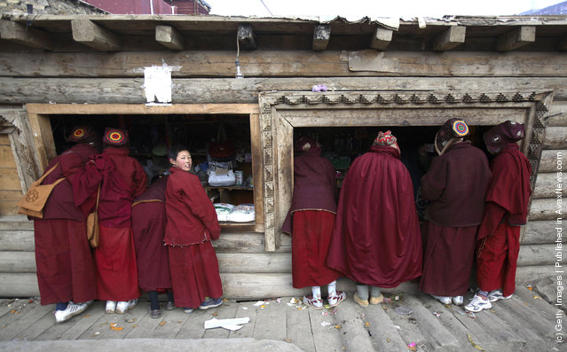 Nuns buy goods outside a store at the Serthar Wuming Buddhist Study Institute