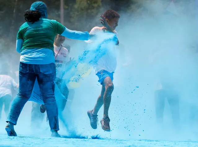 A participant is sprayed with coloured powder during the YARKOcross colour run race in Almaty, Kazakhstan, June 5, 2016. (Photo by Shamil Zhumatov/Reuters)