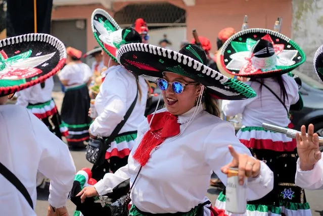 Women dance during a re-enactment of The Battle of Puebla as part of Cinco de Mayo celebrations in the Peñon de los Baños neighborhood of Mexico City, Thursday, May 5, 2022. Cinco de Mayo commemorates the victory of an ill-equipped Mexican army over French troops in Puebla on May 5, 1862. (Photo by Eduardo Verdugo/AP Photo)