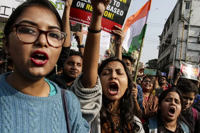 Protestors shout slogand demanding the withdrawal of the Citizenship Amendment Act and National Register of Citizens (NRC) in Kolkata, India, Thursday, December 19, 2019. Police detained several hundred protesters in some of India's biggest cities Thursday as they defied a ban on assembly that authorities imposed to stop widespread demonstrations against a new citizenship law that opponents say threatens the country's secular democracy. (Photo by Bikas Das/AP Photo)