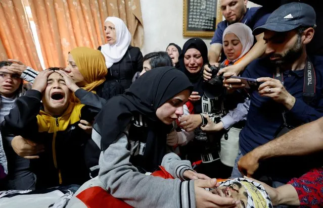 Relatives react next to the body of Palestinian Mohammed Ghoneim, who medics say was killed by Israeli forces, during his funeral near Bethlehem, in the Israeli-occupied West Bank on April 11, 2022. (Photo by Mussa Qawasma/Reuters)