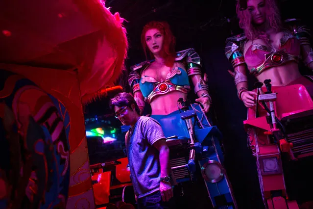 A staff member works to prepare two large female robots prior to the start of a show at The Robot Restaurant on June 29, 2014 in Tokyo, Japan. The now famous Robot Restaurant opened two years ago in Kabukicho area of Shinjuku at an estimated cost of 10 million U.S. dollars. (Photo by Chris McGrath/Getty Images)