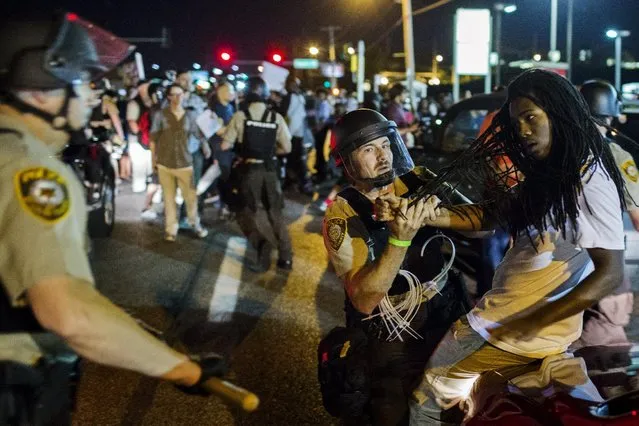 St Louis County police officers arrest an anti-police demonstrator in Ferguson, Missouri August 10, 2015. (Photo by Lucas Jackson/Reuters)