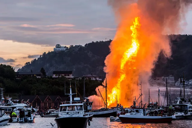 What is now known as the world's largest bonfire burns in Alesund, Norway, June 25, 2016. Picture taken June 25, 2016. The bonfire made up of pallets measured 47.4 meters into the air. (Photo by Runar Andersen/Reuters/NTB Scanpix)