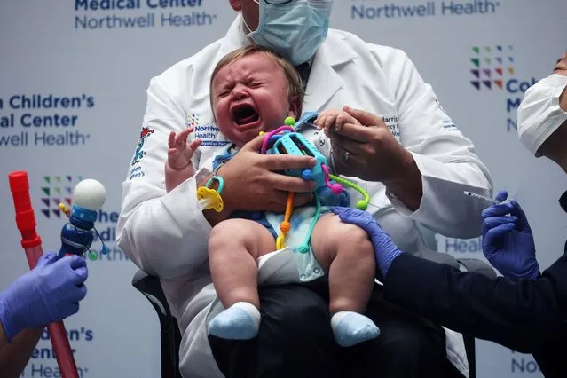 Oliver Harris, 9 months, cries after receiving a vaccine against the coronavirus disease (COVID-19) at Northwell Health's Cohen Children's Medical Center in New Hyde Park, New York, U.S., June 22, 2022. (Photo by Shannon Stapleton/Reuters)