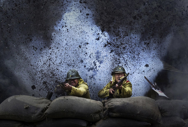 An explosion goes off as Chinese actors playing Japanese soldiers are are filmed in a battle scene during filming of the series “The Last Noble”, set during the second Sino-Japanese War on August 13, 2015 in Fangyan, China. Seventy years after the end of World War II, there is still widespread resentment across China toward Japan and its wartime misdeeds. (Photo by Kevin Frayer/Getty Images)
