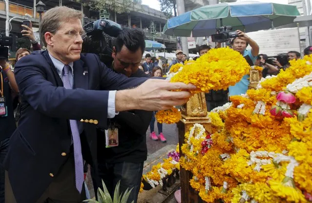 U.S. Charge d'Affaires W. Patrick Murphy places a wreath at the Erawan shrine, the site of Monday's deadly blast, in central Bangkok, Thailand, August 19, 2015. (Photo by Kerek Wongsa/Reuters)