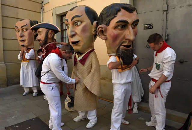 Assistants help “Kilikis”, Big Heads, to dress at the San Fermin festival in Pamplona, northern Spain July 8, 2016. (Photo by Eloy Alonso/Reuters)