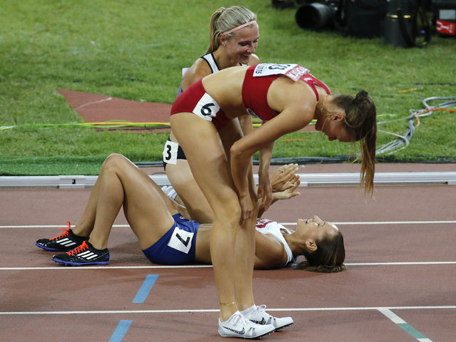 Jessica Ennis-Hill of Britain (7) is congratulated by Brianne Theisen-Eaton of Canada (back) after the 800 metres event of the women's heptathlon at the IAAF World Championships at National Stadium in Beijing, China August 23, 2015. (Photo by Fabrizio Bensch/Reuters)