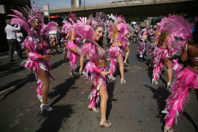 Costumed revellers perform in the Notting Hill Carnival in London, Monday, August 28, 2017. The carnival has been held every year since 1966 and one of the largest festival celebrations of its kind in Europe. (Photo by Tim Ireland/AP Photo)