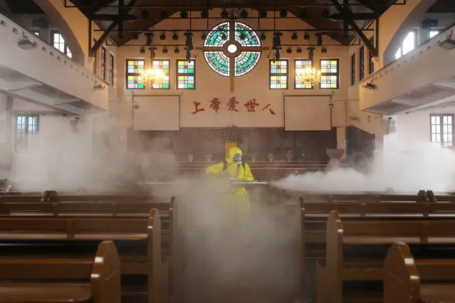 A worker disinfects the Hankou Salvation Church in Wuhan, in China's central Hubei province on March 6, 2020. China reported 30 more deaths from the new coronavirus outbreak on March 6, with fresh infections rising for a second straight day and 16 new cases imported from overseas. Over 80,500 people have now been infected in mainland China, which has imposed a series of dramatic measures to try and contain the spread of infections beyond the epicentre, central Hubei province. (Photo by AFP Photo/China Stringer Network)