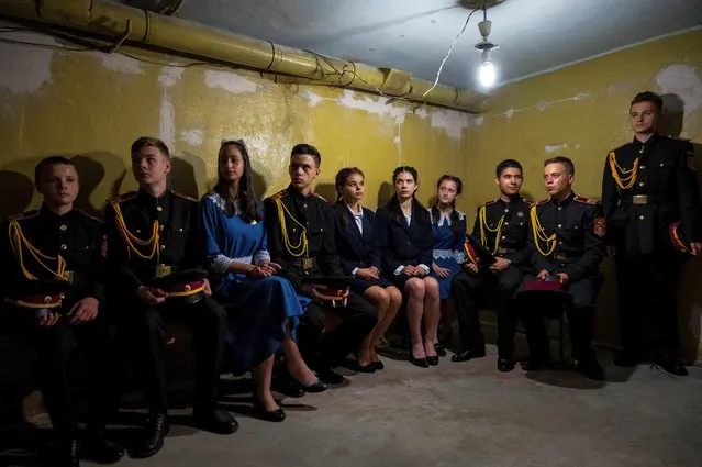 Students sit inside a bomb shelter of a cadet lyceum as they conduct an air-raid alarm actions training amid Russia's attack on Ukraine continues, in Kyiv, Ukraine on July 27, 2022. (Photo by Viacheslav Ratynskyi/Reuters)