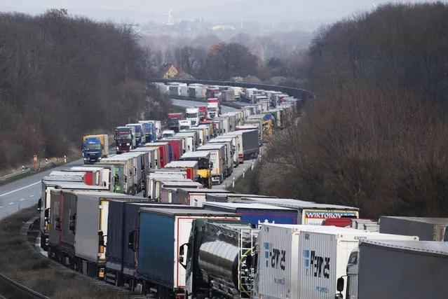 Trucks are jammed on the motorway A4  near Bautzen, Germany, Tuesday, March 17, 2020. Because of the controls at the border with Poland, a traffic jam formed on the Autobahn 4 between Dresden and Goerlitz, which, according to police, had grown to a length of 40 kilometers by noon. For most people, the new coronavirus causes only mild or moderate symptoms, such as fever and cough. For some, especially older adults and people with existing health problems, it can cause more severe illness, including pneumonia. (Photo by Robert Michael/dpa via AP Photo)