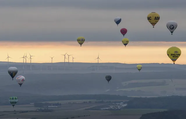 Hot air balloons start during the 27th International Warsteiner Montgolfiade at the airport Paderborn/Lippstadt in Bueren, Germany, Tuesday, September 5, 2017. More than 200 teams from 11 countries are expected for the event, lasting from the 1st to the 9th of September. (Photo by Bernd Thissen/DPA via AP Photo)