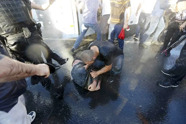 A civilian beats a soldier after troops involved in the coup surrendered on the Bosphorus Bridge in Istanbul, Turkey July 16, 2016. (Photo by Murad Sezer/Reuters)