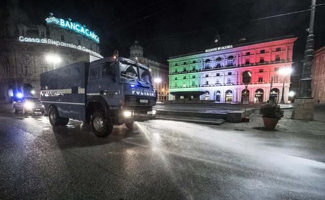 An Italian Police's water cannon truck, usually deployed to disperse groups of demonstrators, delivers a ssanitation operation in the streets of the center of Genoa, Italy, 29 March 2020. The vehicle has been adapted and is now used for the sanitation of the city's streets to counter a further widespread of the SARS-CoV-2 coronavirus, which causes the Covid-19 disease. (Photo by Luca Zennaro/EPA/EFE)